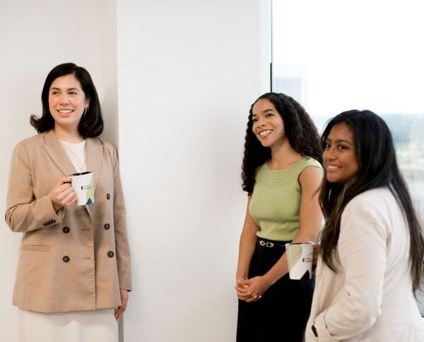 Coworkers laughing at something off camera