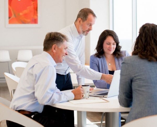 Sands colleagues sitting together at a circular table