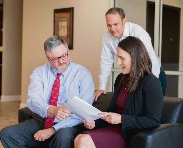 Sands Anderson team members meeting over a document