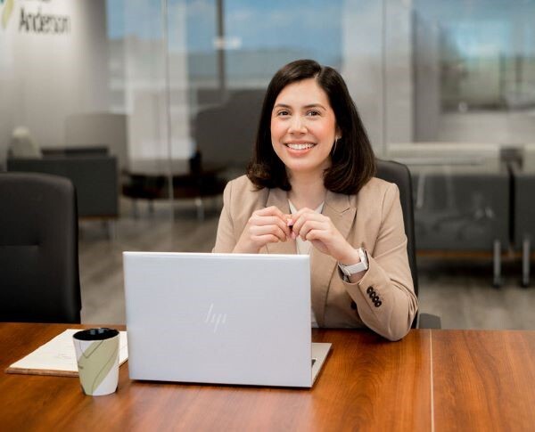 Woman sitting at conference room desk with laptop